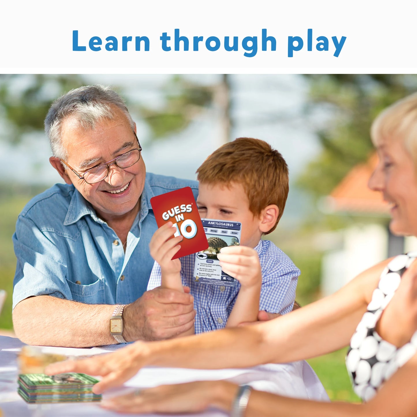 Family playing Guess in 10 World of Dinosaurs card game for ages 8 and up