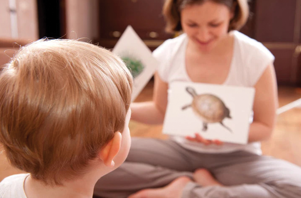 Mother teaching about animals to kids