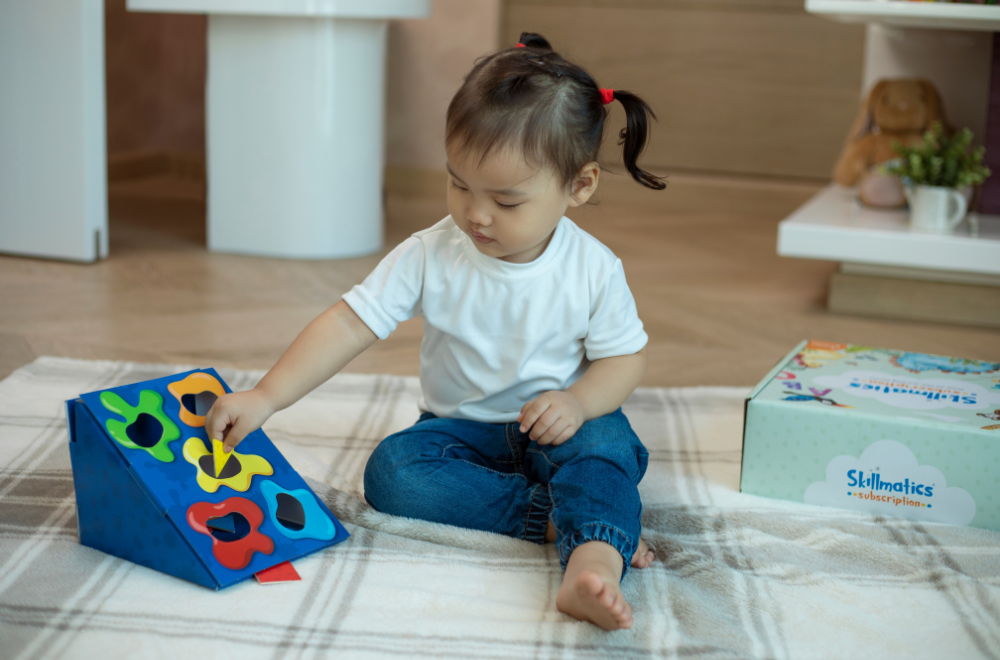 A baby girl playing with subscription box