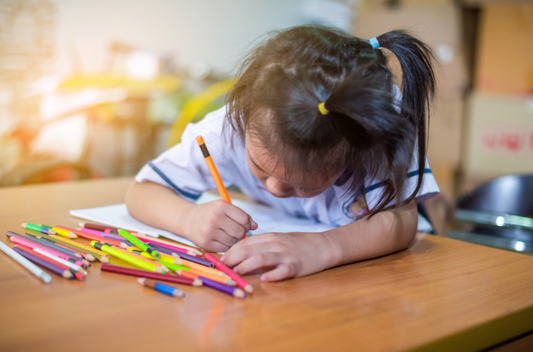 Kid doing activity with color pens