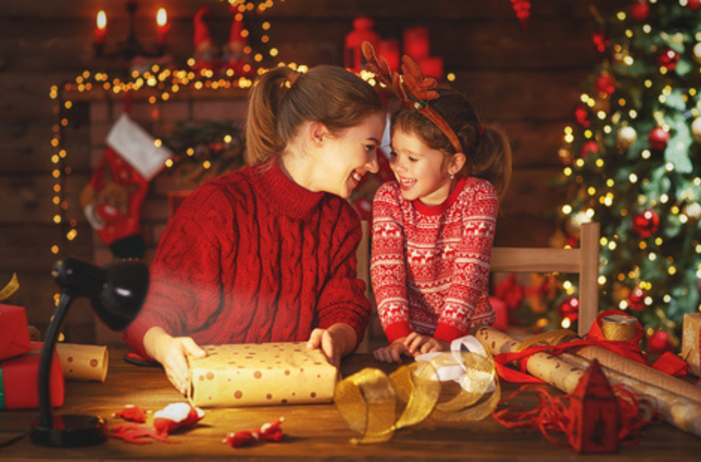 Mother and daughter in Christmas sweater smiling