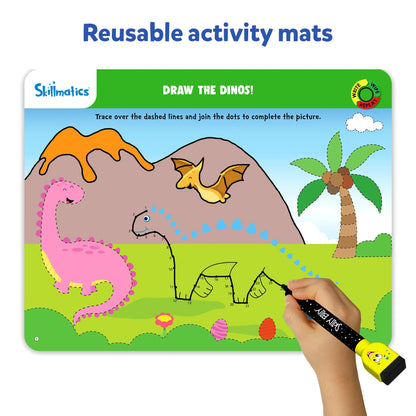 Reusable activity mat from Skillmatics Preschool Champion titled “Draw the Dinos.” The mat shows dinosaurs and a volcano background, with dashed lines and dots for children to trace and complete the picture using the dry-erase marker.