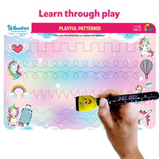 Skillmatics educational mat with playful patterns and a hand holding a pen.