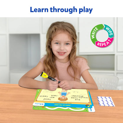 Young girl using Skillmatics I Can Write activity mats at a table, holding the included dry-erase marker. Text overlay: “Learn through play.” Demonstrates engaging handwriting practice through tracing and repeatable activities.