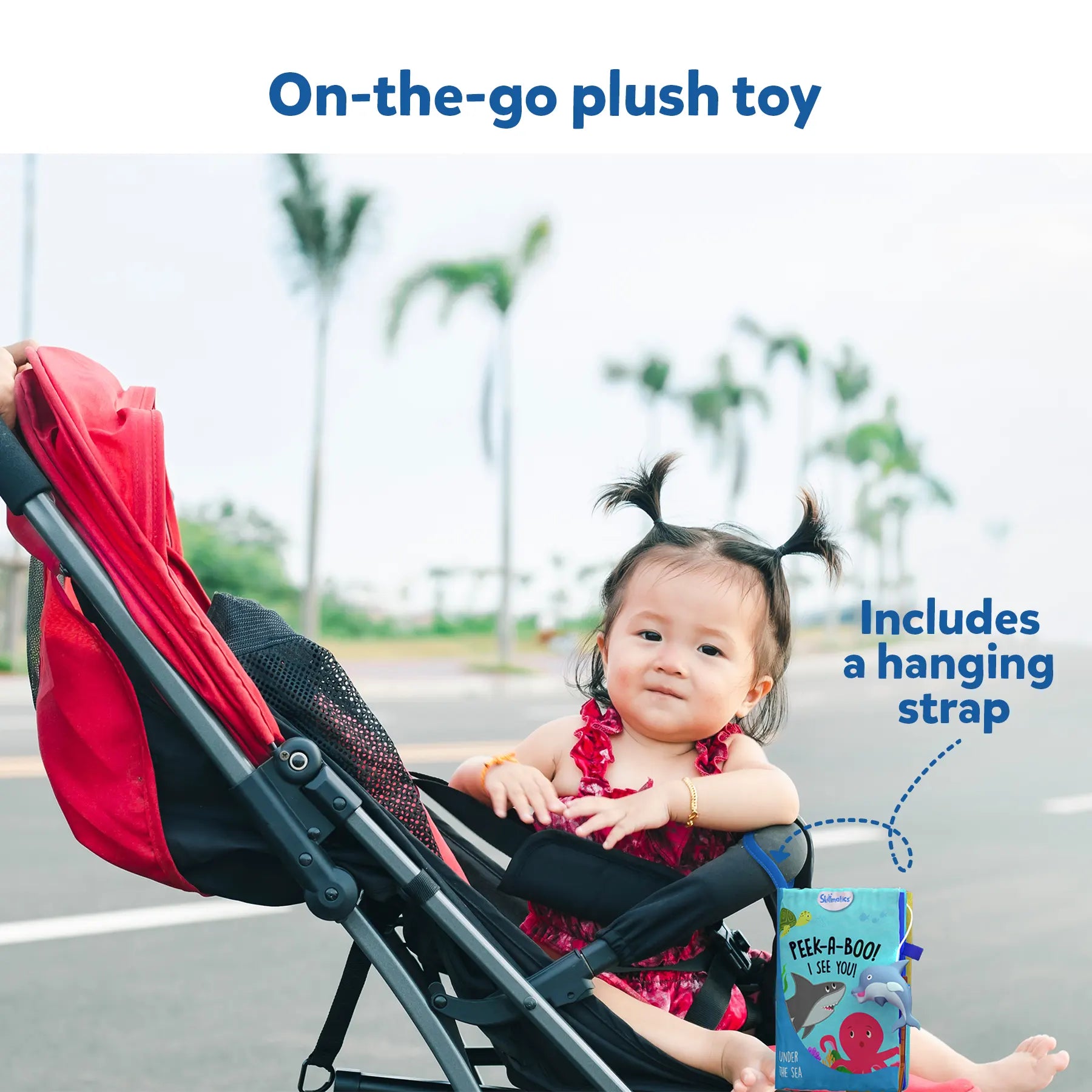 Baby in a stroller reading Peek-A-Boo Underwater Animals Interactive Cloth Book