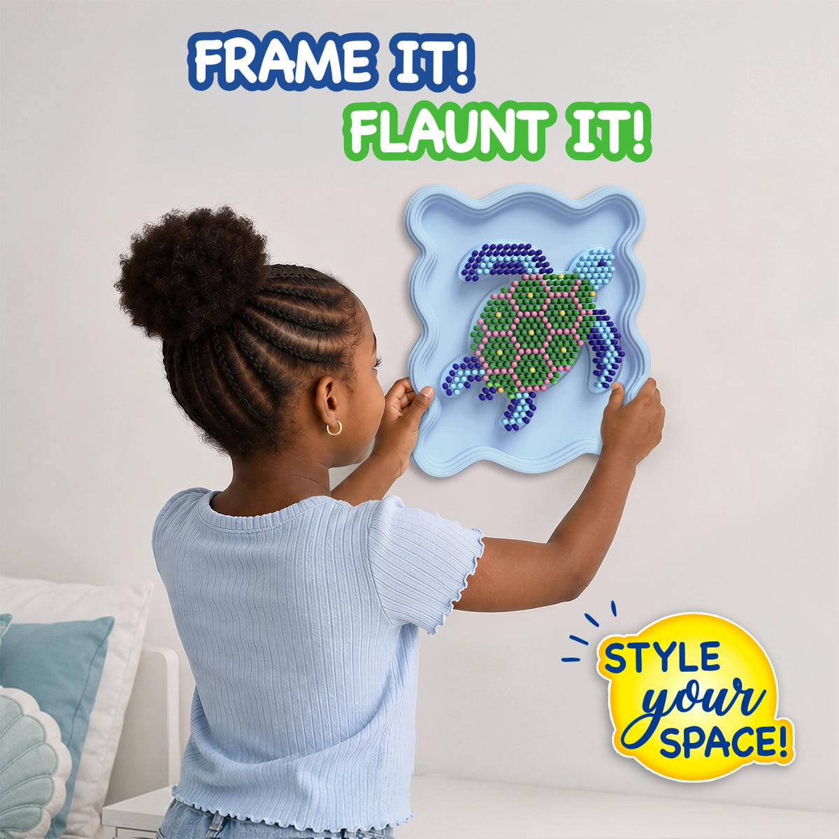 Child placing a completed Skillmatics Stixels Sea Turtle artwork onto a bedroom wall. The framed 3D wall decor features colorful Stixels arranged on a turtle-shaped design inside a light blue frame. The image showcases the finished DIY craft as personalized room décor for kids.