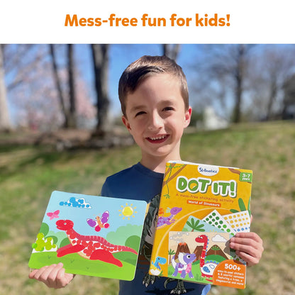 Smiling boy holding Dinosaur-themed sticker activity set from Dot it World of Dinosaurs