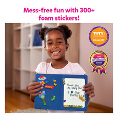 Smiling girl holding a decorated blue board from Foil Fun Card Making Set for ages 4-9